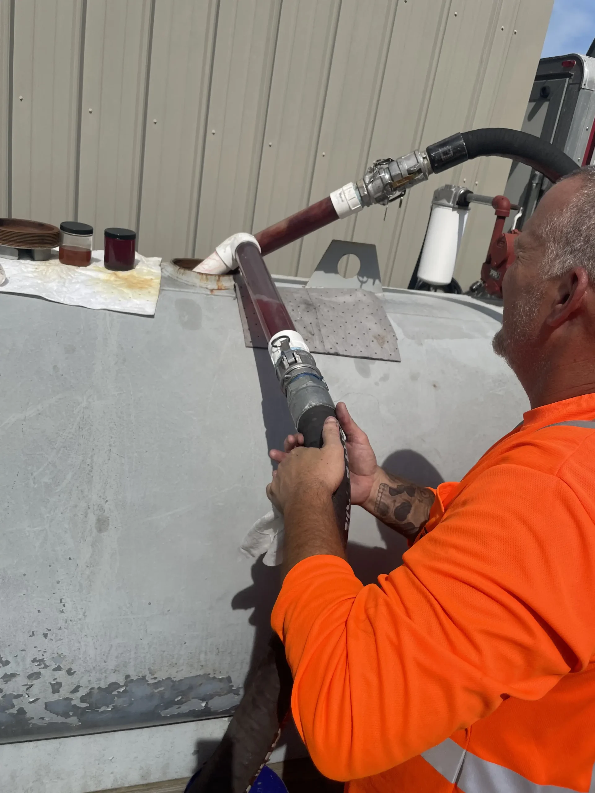 Fuel Quality Specialist cleans contaminated fuel tank at job site